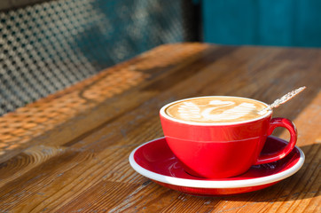 Red cup with cappuccino.