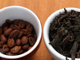 Raw coffee and tea. Dry coffee and tea in a cup.