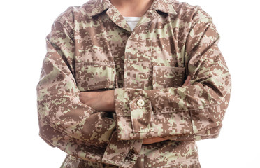 Young soldier with crossed arms isolated on white background