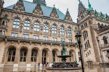 Fototapeta premium Hygieia fountain in the courtyard of Hamburg City Hall in a cold rainy early spring day