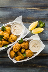 Fried cauliflower in batter with a savory sauce of cashew nuts. healthy vegan fast food. Baked Buffalo Cauliflower 