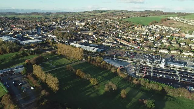 Aerial footage over the town of Bathgate in West Lothian, Scotland. Flying away.