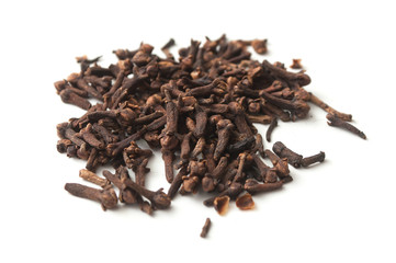 closeup of cloves pile on white background