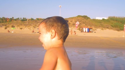 Slow motion - Two little brothers running, playing and enjoying while the camera chase them smiling and laughing