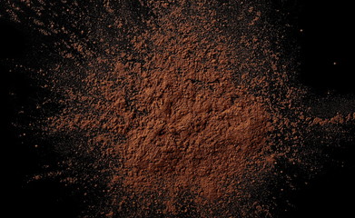Fototapeta na wymiar pile cocoa powder pile on black background, top view