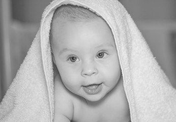 portrait of a little beautiful boy wrapped in a towel