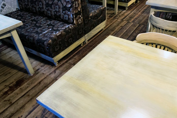 Fototapeta na wymiar White wooden table and black sofa in restaurant