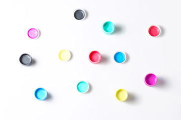 acrylic paint in cans on a white background. flat lay, top view