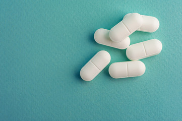 multi colored and white pills are on the table