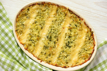 Zucchini and potatoe casserole with cheese,  vegetarian food.