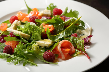 Gourmet salad with salmon on plate