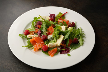 Fresh salad with salmon and cheese on plate
