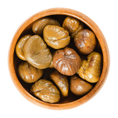 Cooked sweet chestnuts in wooden bowl. Edible seeds or nuts of Castanea sativa, also called marron...