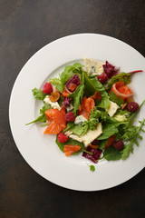 Fresh salad with salmon and cheese top view