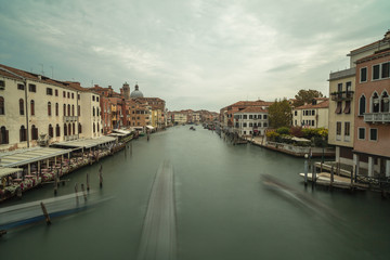 View on Grand Canal with passing by boat in Venice,long exposure photo.