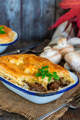 Steak and mushroom pie on rustic wooden backgournd