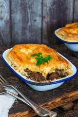 Steak and mushroom pie on rustic wooden backgournd