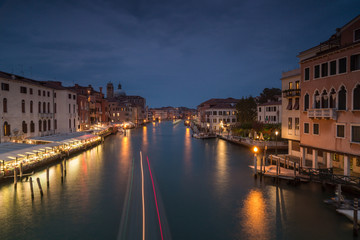 Fototapeta na wymiar Night view on Grand Canal with passing by boat in Venice,long exposure photo.