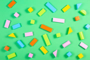 Colorful wooden cubes pattern on green color background