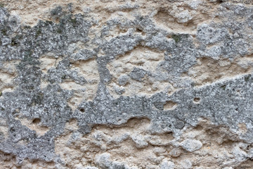 Damaged plaster on the wall of an old building_