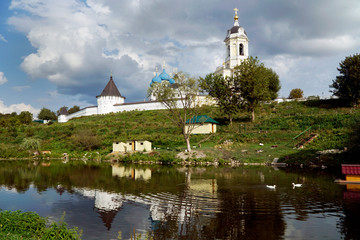 summer landscape with pond, monastery and ducks