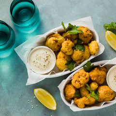 Fried cauliflower in batter with a savory sauce of cashew nuts. healthy vegan fast food. Baked...