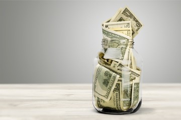 Glass jar for money on background