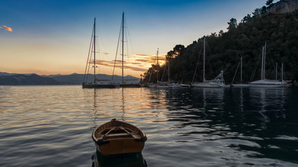 Moored yachts and wooden dinghy, Portofino Alba