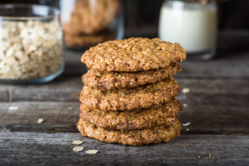 Homemade oatmeal cookies on wooden board on old table background. Healthy Food Snack Concept. Copy space. Milk and cookies. Still life of food. Vegetarian food. Healthy food. Breakfast concept.