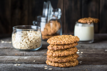 Homemade oatmeal cookies on wooden board on old table background. Healthy Food Snack Concept. Copy space. Milk and cookies. Still life of food. Vegetarian food. Healthy food. Breakfast concept.