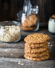 Homemade oatmeal cookies on wooden board on old table background. Healthy Food Snack Concept. Copy space. Milk and cookies. Still life of food. Vegetarian food. Healthy food. Breakfast concept.