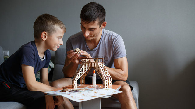 Young boy assembling constructor with his father