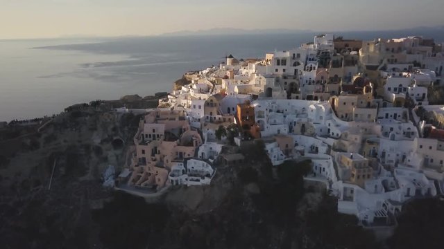Sunset over Greek town of Oia, aerial