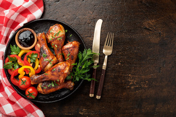 Grill chicken legs. Grilled chicken legs BBQ with sauce, parsley and tomato.