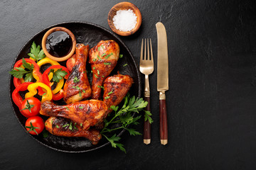 Grill chicken legs. Grilled chicken legs BBQ with sauce, parsley and tomato.