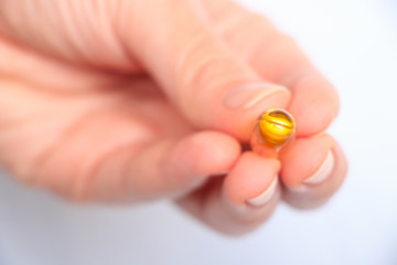 Nutrition. Healthy Lifestyle. Woman Holding Capsule With Fish Oil Omega-3. Supplements, Vitamins.