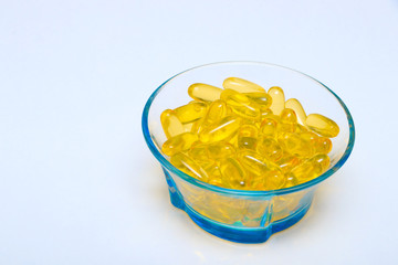 Omega 3 fish oil capsules in bowl