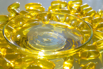 Omega 3 fish oil capsules in bowl