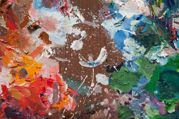 Background image of bright oil paint palette closeup