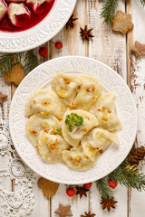 Dumplings with mushroom cabbage filling on a white plate. Vegetarian food, Traditional Christmas eve dish in Poland