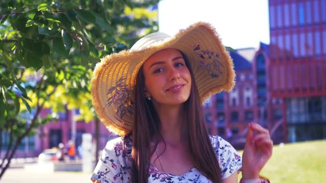 Portrait of a young pretty woman wearing a hat on a sunny summer day.