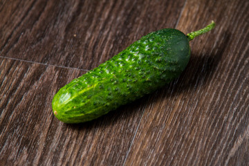ripe cucumber lies on the table