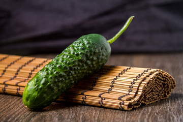 ripe cucumber lies on the table