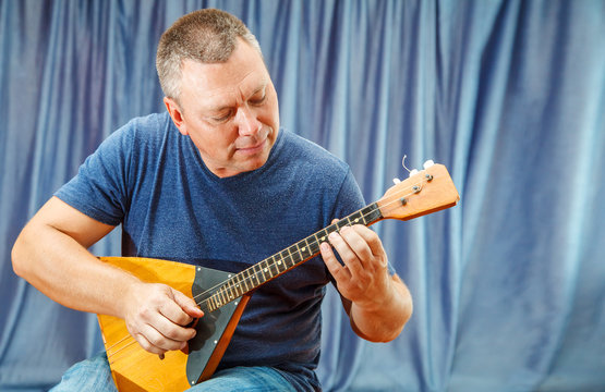 man playing the balalaika