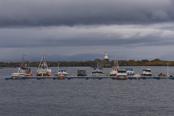 Fototapeta premium Boats and the lighthouse in Hovsund, Lofoten, Norway