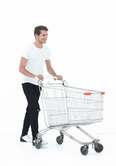 smiling man pushing shopping cart.