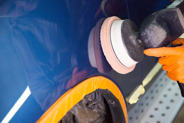 Repair and painting car car mechanic. Auto mechanic worker painting car in a paint chamber during...