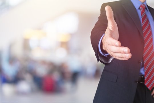 Man Wearing A Business Suit Reaching Hand