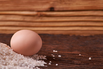 Bunch of rice and uncooced eggs on wooden table. Concept health food