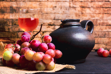 Fresh grape and homemade wine on a table